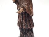 an image of a statue of a man standing on top of a table