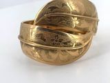 an image of a close up of a gold ring on a white surface