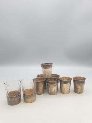 six tasses de café sont alignées les unes à côté des autres sur une surface blanche