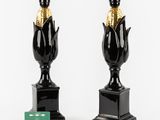 pair of black and gold vases with corn on the cob