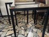 a table and chairs in a room with a stone floor
