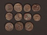 a close up of a bunch of coins on a black surface