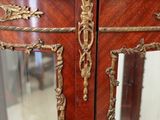a wooden display case with a glass door on it