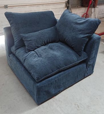 a blue couch with pillows on it in a room