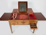 a small wooden table with a mirror on top of it