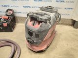 a machine that is sitting on the floor with a hose