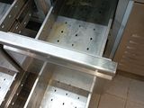 a stainless steel table with a drawer in the middle