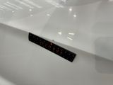 a close up of a white car with a black and red sticker on it