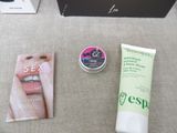 a box with a toothbrush, a tube of toothpaste, and a box with a lip balm on it