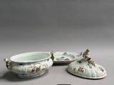 two white dishes with flowers on them sitting on a table