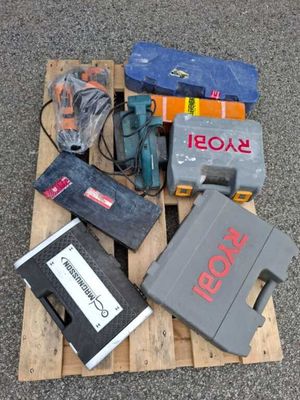 a pile of tools on a pallet on the ground
