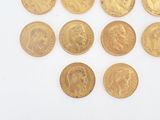 several gold coins are arranged in a circle on a white surface