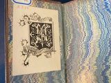 a hand holding a book with a drawing on it