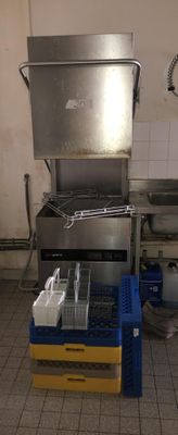 a kitchen with a stove, sink, and other items in it