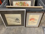 three framed pictures of mountains and trees are sitting on the floor
