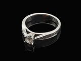 a close up of a diamond ring on a black surface