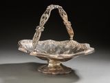 an antique silver plated bowl with a handle on a stand