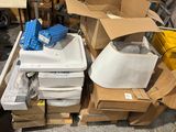 a pile of boxes and a sink in the middle of a room