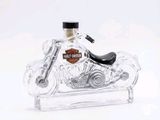 a glass bottle with a motorcycle inside of it