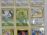 pokemon cards are displayed on a table in a display case