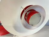 a red and white light that is on top of a white table