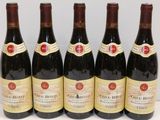 six bottles of wine are lined up on a table