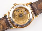 a watch that is sitting on a brown leather strap