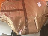 a large brown bag sitting on top of a white chair