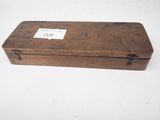 an old wooden box with a label on it sitting on a table