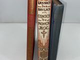 three books are stacked on top of each other on a table