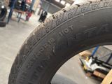 tire tread of a motorcycle with writing on it in a garage
