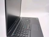 a laptop computer sitting on a table with a keyboard