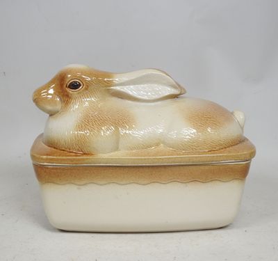 a ceramic rabbit sitting on top of a dish