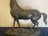 a statue of a horse that is standing on a table