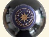 a close up of a wine bottle with a star on it