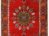 a red rug with a medallion design on it