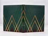 an old book with a green cover and gold trim