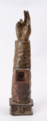 a statue of a hand that is on a stand