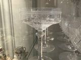 a glass display case with a lot of glasses on it