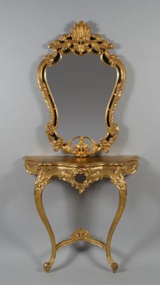 an ornately decorated gold table with a mirror on top of it