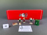 toy figurines in a red box on a gray surface