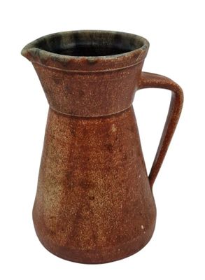 a brown pitcher with a handle on a white background