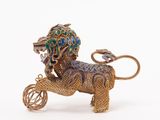 a gold lion with a carton of jewels on it ' s back