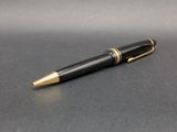 an image of a black and gold ballpoint pen