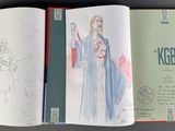 an open book with a drawing of a woman holding a sword