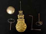 a gold clock that is sitting on a black table