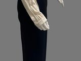 an image of a mannequin wearing a white shirt and black pants