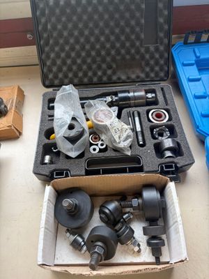 a box of tools sitting on a table next to a blue case