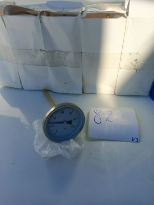 a clock that is sitting on a table next to a bag