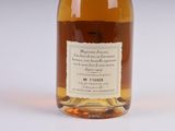 a bottle of whiskey sitting on a white surface